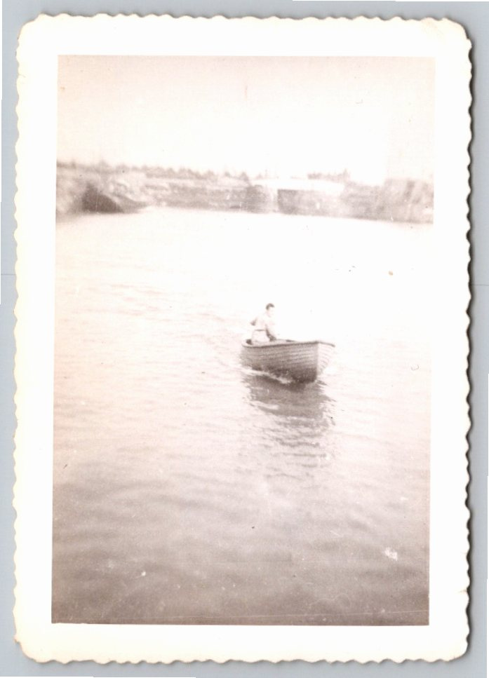 Vintage 1950s Black & White Snapshot of Man Rowing Wooden Boat