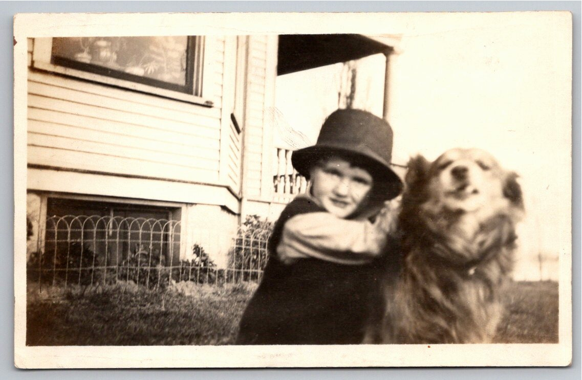Vintage c.1910 Real Photo Postcard: Boy Hugging Dog in Oversized