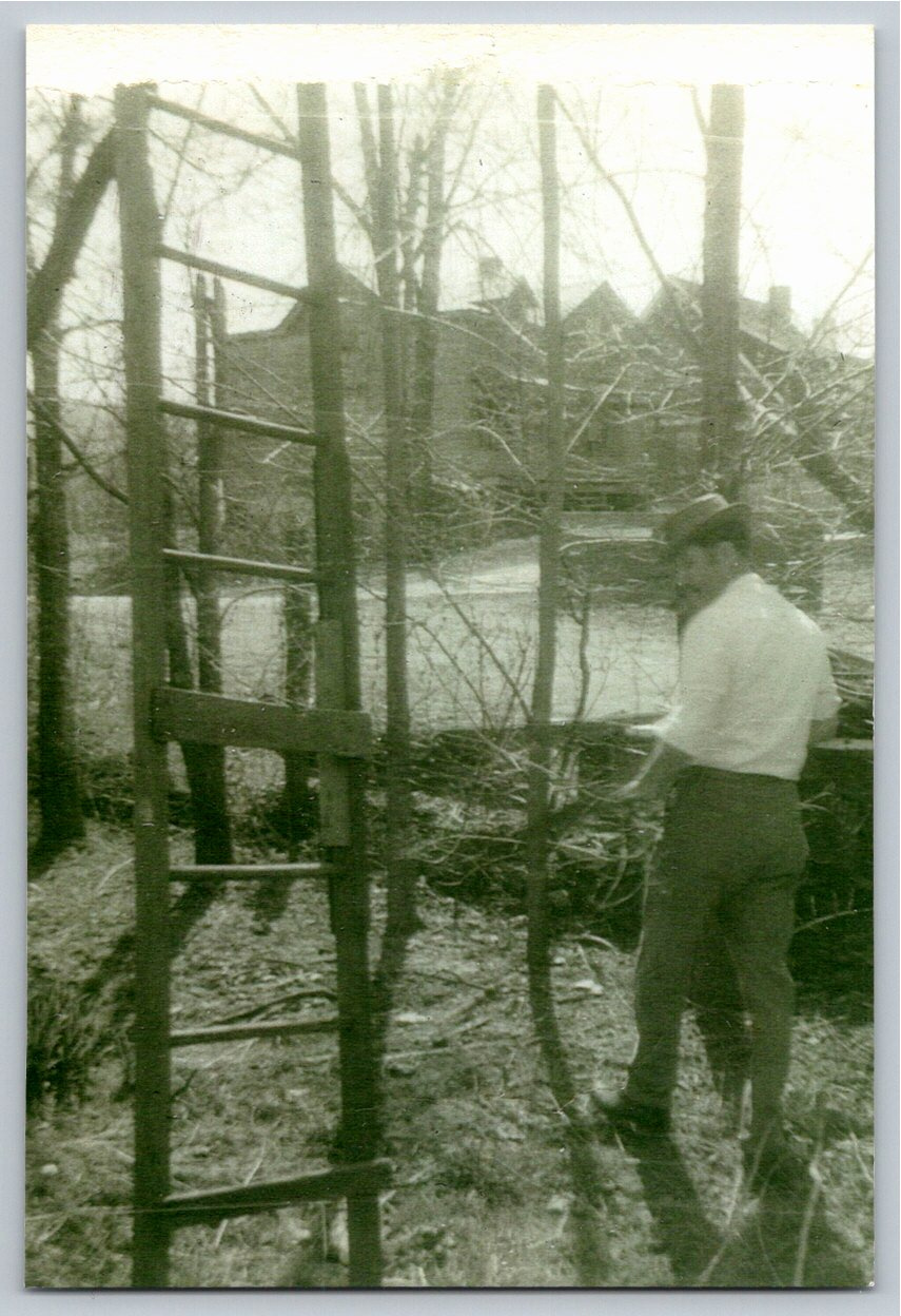 Vintage 1920s Black & White Snapshot: Man with Wooden Ladders
