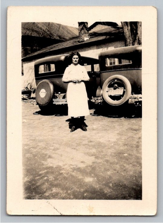 Vintage 1920s Black & White Photo: Woman with Classic Sedans